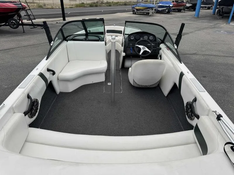 Slide: The Image of 1999 MasterCraft Powerstar 200 boat interior with white seating and dashboard view. - 7