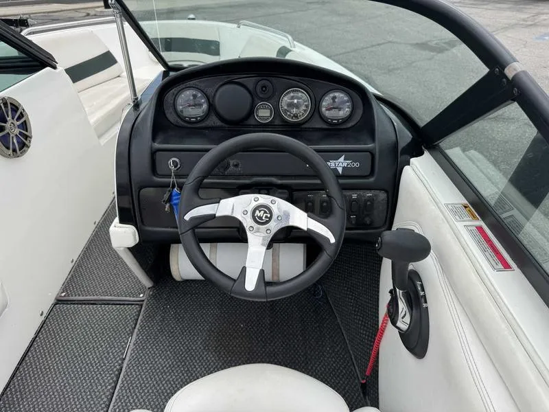 Slide: The Image of 1999 MasterCraft Powerstar 200 boat dashboard with steering wheel and gauges. - 8