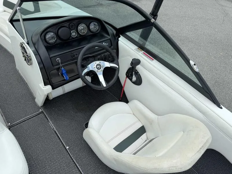 Slide: The Image of 1999 MasterCraft Powerstar 200 boat interior with steering wheel and dashboard controls. - 9