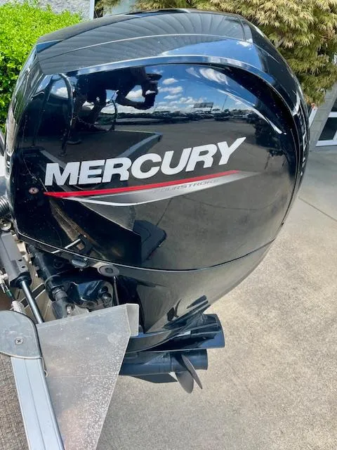 Slide: The Image of Mercury outboard motor on 2023 Barletta Cabrio 22UC boat, black finish, outdoor setting. - 14