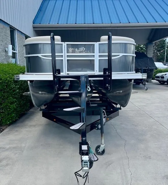 Slide: The Image of 2023 Barletta Cabrio 22UC pontoon boat on trailer, parked outdoors. - 3
