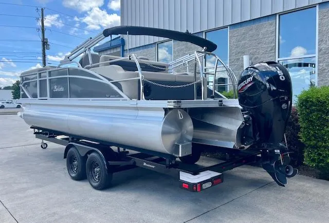 Slide: The Image of 2023 Barletta Cabrio 22UC pontoon boat on trailer, parked outdoors. - 4