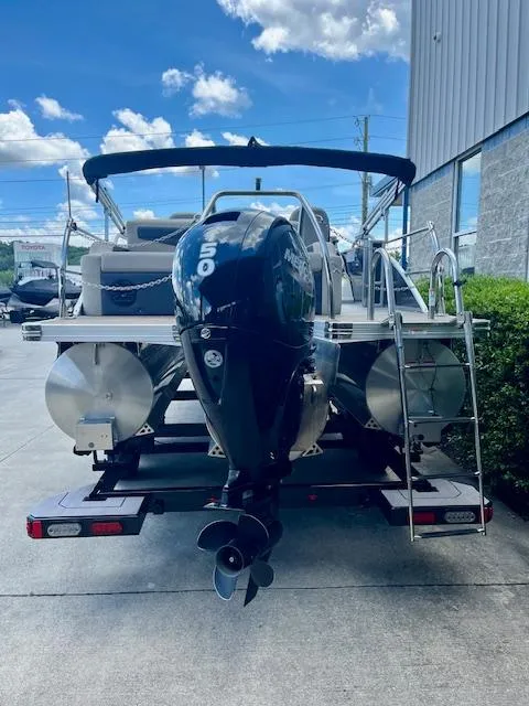 Slide: The Image of 2023 Barletta Cabrio 22UC pontoon boat with powerful outboard motor, parked outdoors. - 5