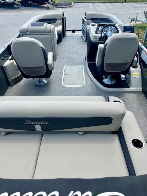Slide: The Image of 2023 Barletta Cabrio 22UC pontoon boat interior with seating and steering console. - 7