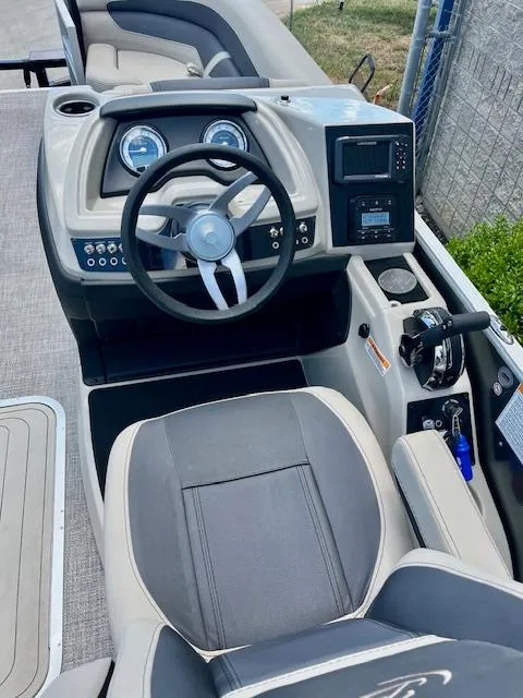 Slide: The Image of 2023 Barletta Cabrio 22UC boat cockpit with steering wheel and control panel. - 8