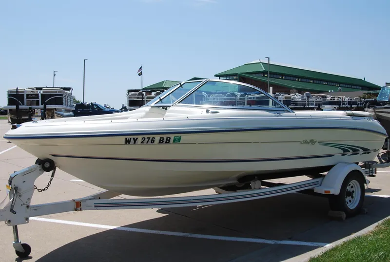 Slide: The Image of 1997 Sea Ray 175 Bow Rider boat on trailer in parking lot. - 3