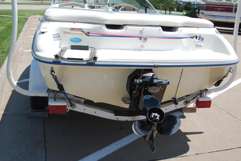 Slide: The Image of 1997 Sea Ray 175 Bow Rider boat rear view with outboard motor on trailer. - 4