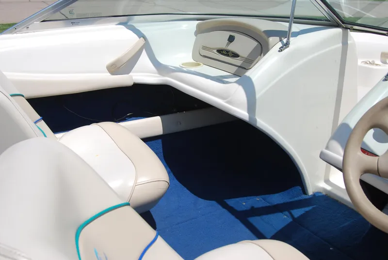 Slide: The Image of 1997 Sea Ray 175 Bow Rider interior with beige seats and blue carpet. - 6