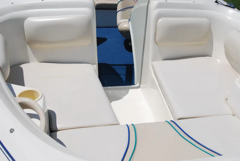 Slide: The Image of 1997 Sea Ray 175 Bow Rider interior with white seating and blue accents. - 7
