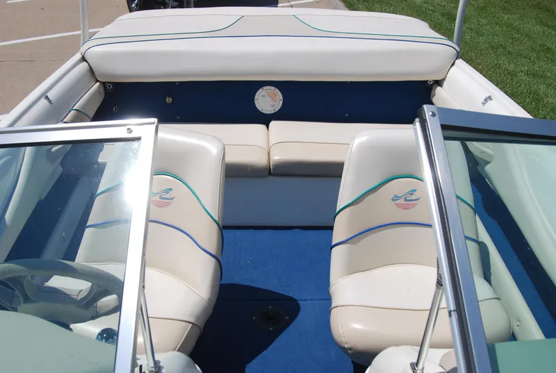 Slide: The Image of 1997 Sea Ray 175 Bow Rider interior with blue carpet and white seating. - 9