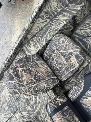 Slide: The Image of 2024 Lowe Stinger 175C boat with camouflage seating and interior design. - 17