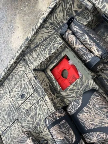 Slide: The Image of 2024 Lowe Stinger 175C boat interior with camouflage design and red life jacket. - 18