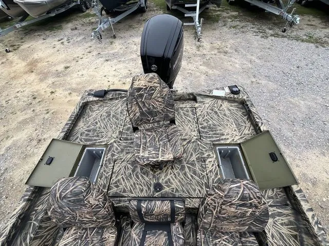 Slide: The Image of 2024 Lowe Stinger 175C boat with camouflage seats and storage compartments. - 20