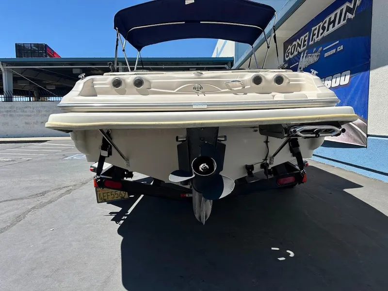 Slide: The Image of 2001 Larson SEi 190 boat on trailer, rear view with propeller and canopy. - 10