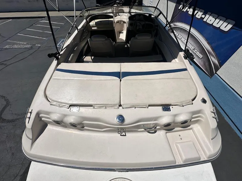 Slide: The Image of 2001 Larson SEi 190 boat, rear view, parked outdoors, showcasing seating and deck area. - 11