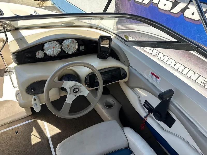 Slide: The Image of 2001 Larson SEi 190 boat dashboard with steering wheel and gauges. - 22