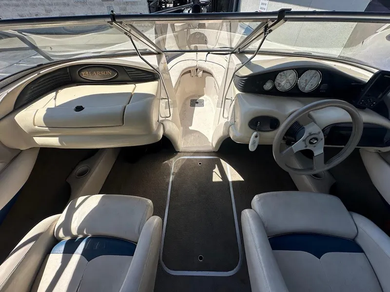 Slide: The Image of Interior of a 2001 Larson SEi 190 boat, featuring steering wheel and dashboard controls. - 26