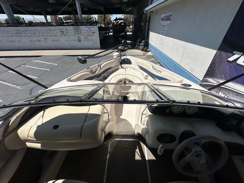 Slide: The Image of Interior view of a 2001 Larson SEi 190 boat, showcasing steering and seating area. - 27