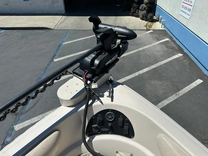 Slide: The Image of 2001 Larson SEi 190 boat with Minn Kota trolling motor in parking lot. - 29