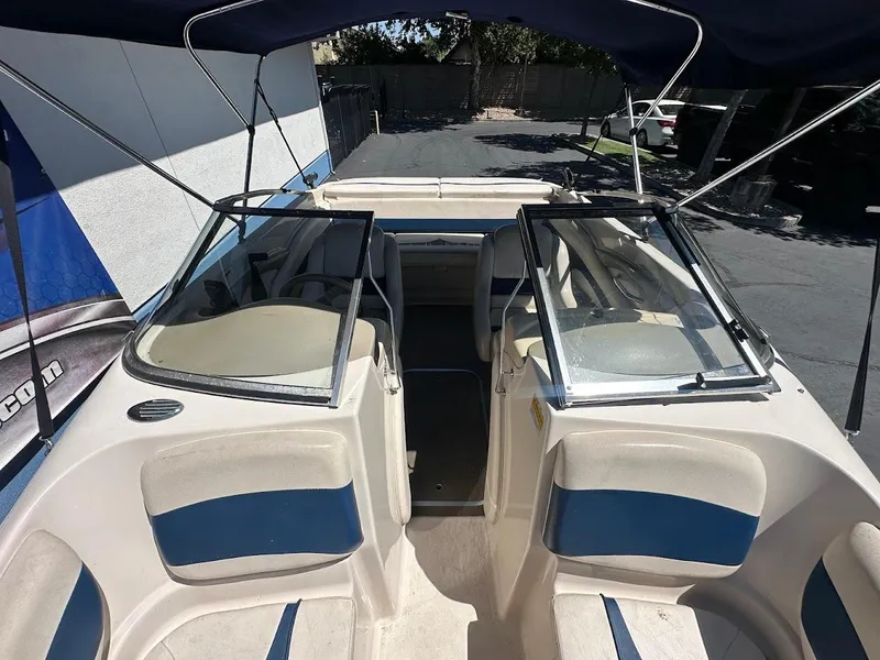 Slide: The Image of 2001 Larson SEi 190 boat interior with blue and beige seating under a canopy. - 32