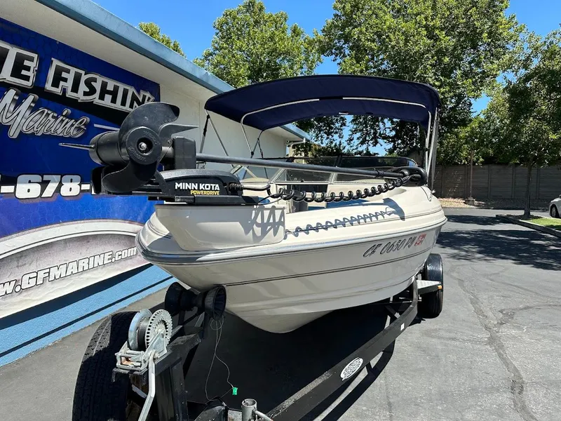 Slide: The Image of 2001 Larson SEi 190 boat with Minn Kota PowerDrive, parked on a trailer. - 5