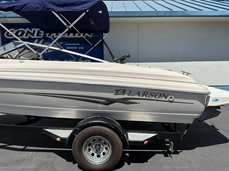 Slide: The Image of 2001 Larson SEi 190 boat on trailer, side view, with blue canopy. - 7