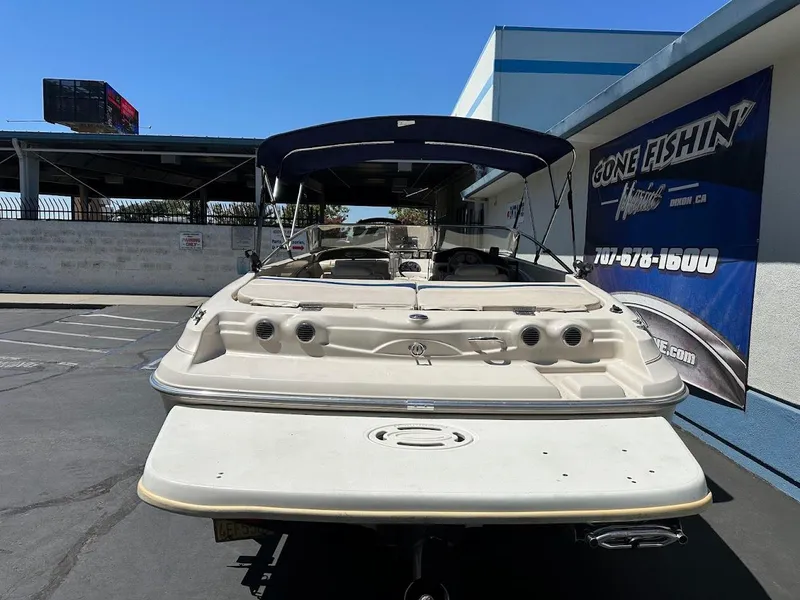 Slide: The Image of 2001 Larson SEi 190 boat with canopy, parked at dealership, rear view. - 9