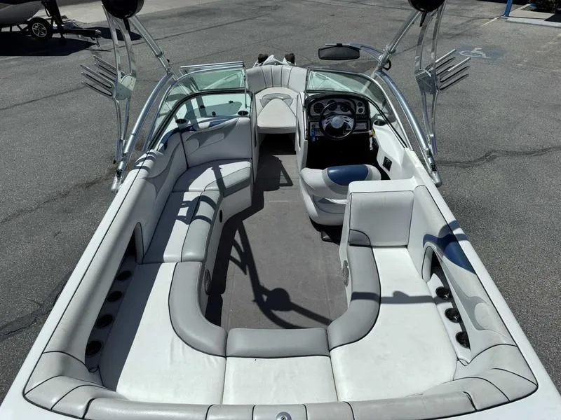 Slide: The Image of Interior of a 2006 Custom B52 23 boat with spacious seating and sleek design. - 11