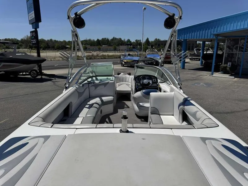 Slide: The Image of Interior view of a 2006 Custom B52 23 boat with seating and steering wheel. - 13
