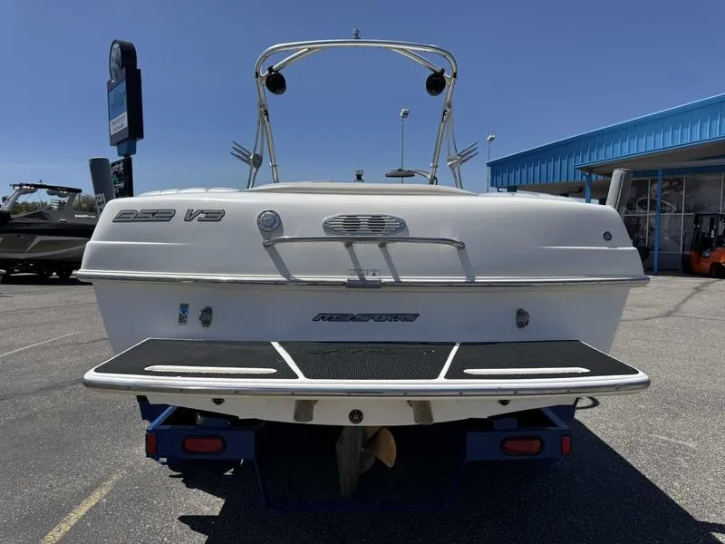 Slide: The Image of Rear view of a 2006 Custom B52 23 boat in a parking lot. - 3