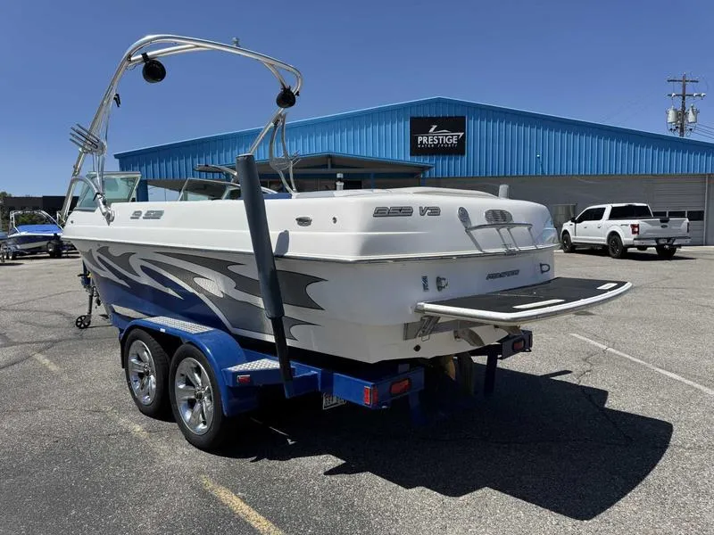 Slide: The Image of 2006 Custom B52 23 boat on trailer, parked outside Prestige dealership. - 4