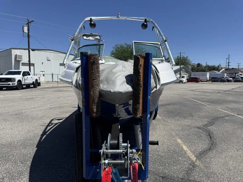 Slide: The Image of Custom B52 23 boat on trailer, covered, parked in lot, sunny day, 2006 model. - 5