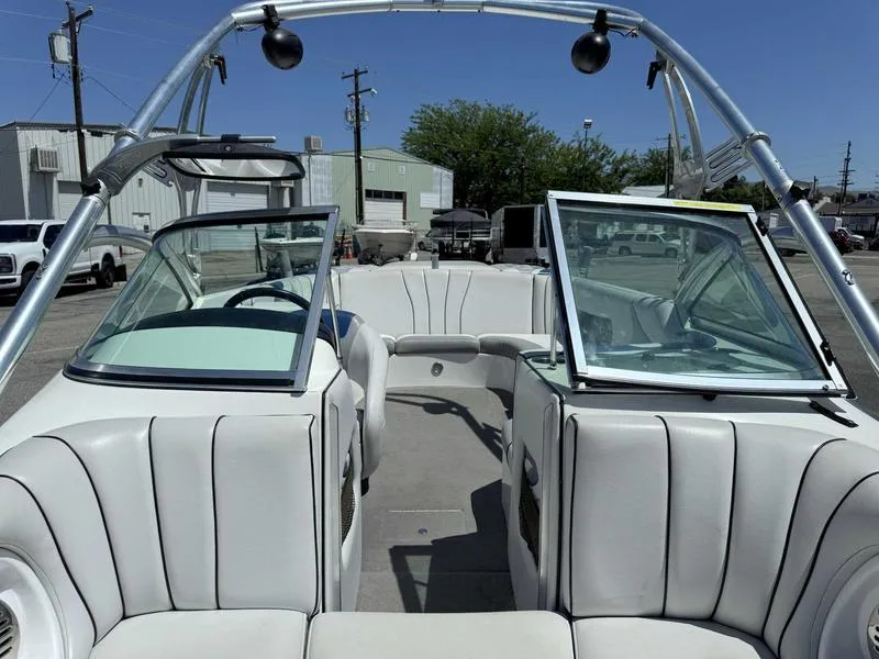 Slide: The Image of Interior view of a 2006 Custom B52 23 boat with white seating and open windshield. - 7