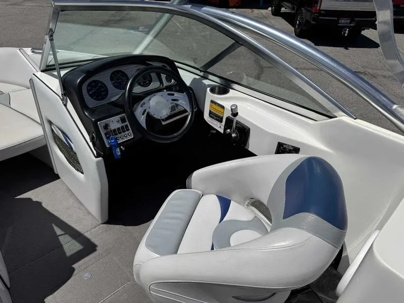 Slide: The Image of Interior of a 2006 Custom B52 23 boat, featuring steering wheel and dashboard controls. - 8