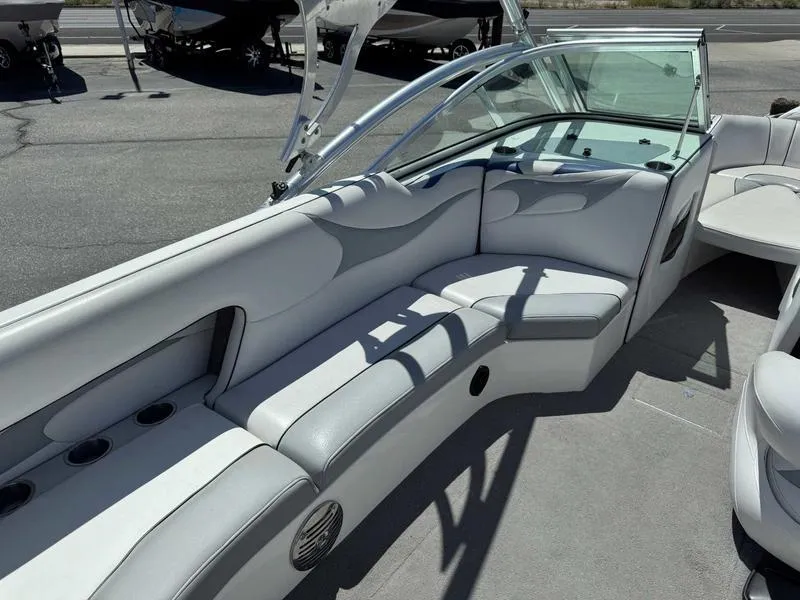 Slide: The Image of Interior of a 2006 Custom B52 23 boat with white seating and cup holders. - 9