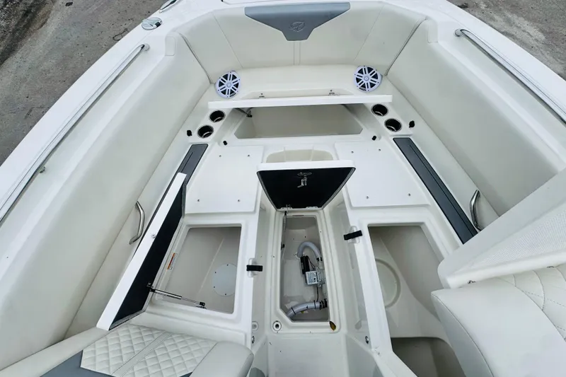 Slide: The Image of 2026 Sailfish 276 DC boat interior with open storage compartments and seating. - 14