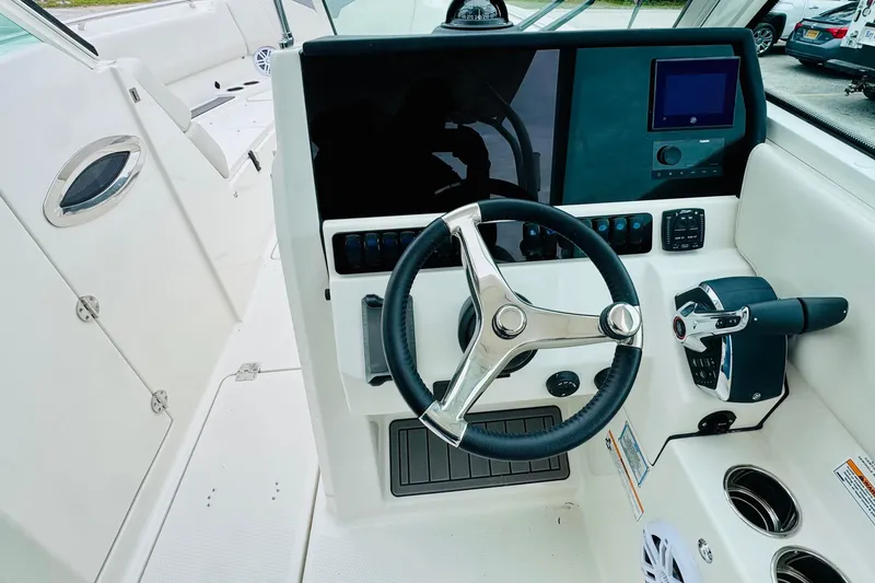 Slide: The Image of 2026 Sailfish 276 DC boat cockpit with steering wheel and control panel. - 21