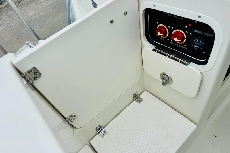 Slide: The Image of Control panel and storage compartment on 2026 Sailfish 276 DC boat. - 22