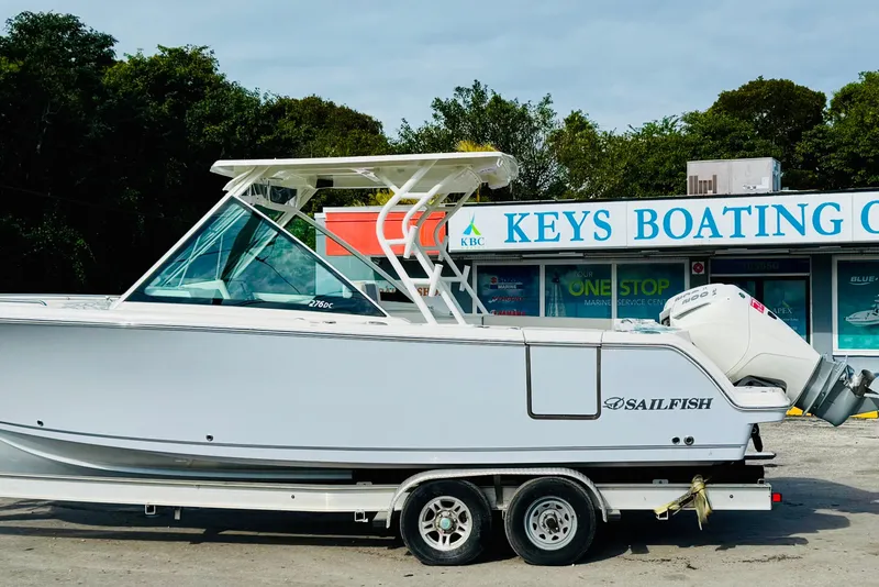 Slide: The Image of 2026 Sailfish 276 DC boat on trailer at Keys Boating Center. - 3