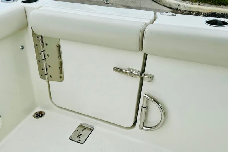 Slide: The Image of 2026 Sailfish 276 DC boat interior, featuring a secure latch and stainless steel hardware. - 30