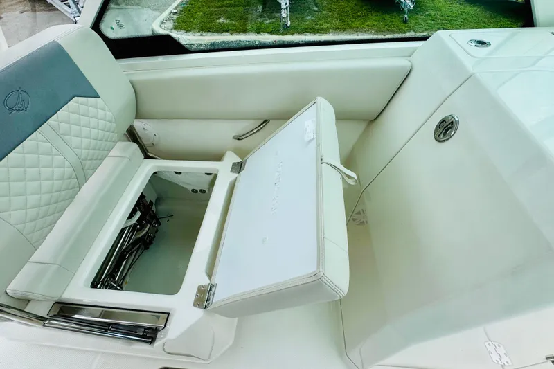 Slide: The Image of 2026 Sailfish 276 DC boat interior with open storage compartment and cushioned seating. - 34