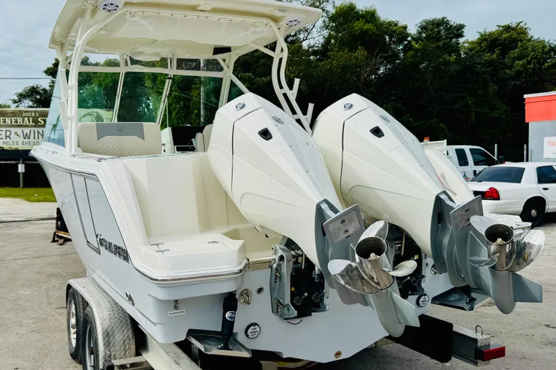 Slide: The Image of 2026 Sailfish 276 DC boat with dual outboard engines on a trailer. - 35