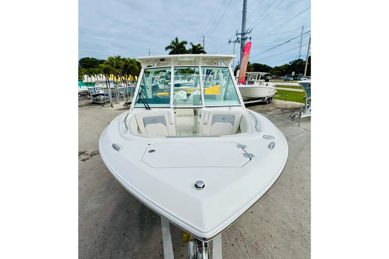 Slide: The Image of 2026 Sailfish 276 DC boat, white exterior, docked outdoors, showcasing spacious seating and sleek design. - 38