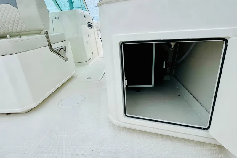 Slide: The Image of 2026 Sailfish 276 DC boat interior with open storage compartment and seating. - 8