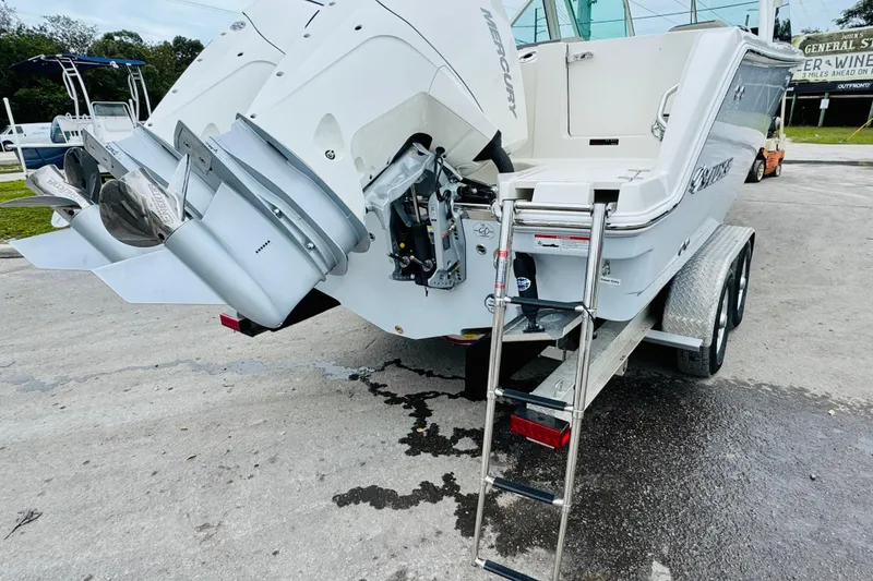 Slide: The Image of 2026 Sailfish 276 DC boat with dual Mercury engines and trailer ladder. - 9