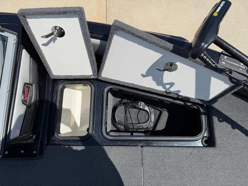 Slide: The Image of 2022 Ranger 1880MS boat storage compartments with open lids and visible equipment. - 12