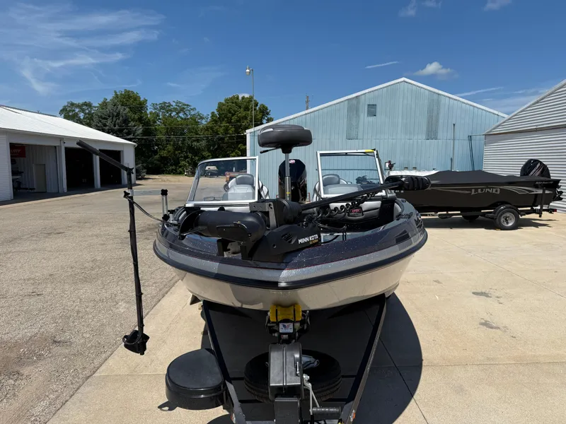 Slide: The Image of 2022 Ranger 1880MS boat parked outdoors, featuring a Minn Kota trolling motor. - 2