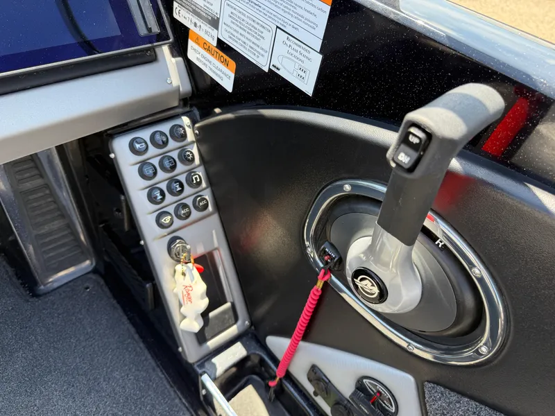 Slide: The Image of Control panel of 2022 Ranger 1880MS boat with gear shift and buttons. - 24