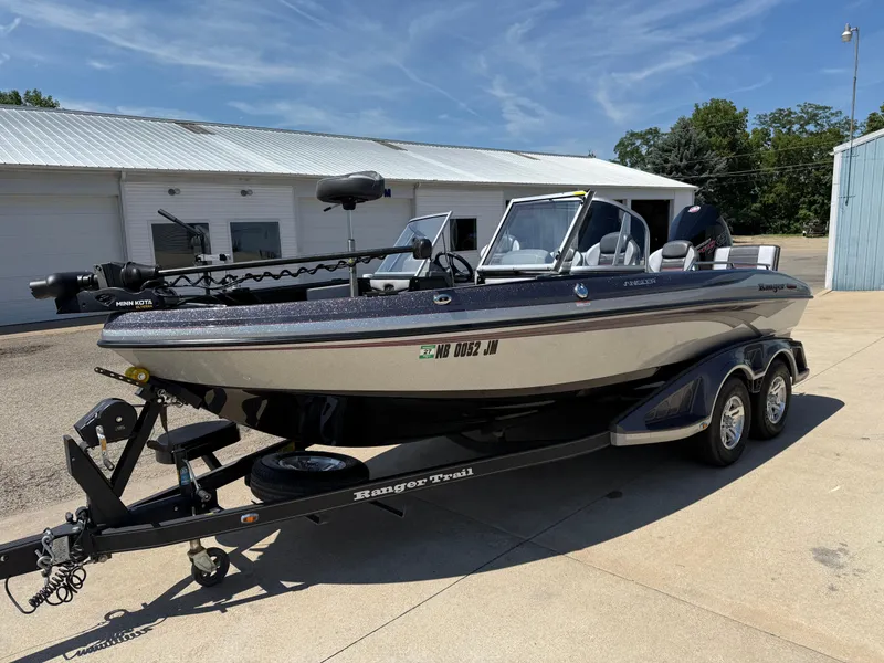 Slide: The Image of 2022 Ranger 1880MS boat on trailer, parked outside a building under clear skies. - 3