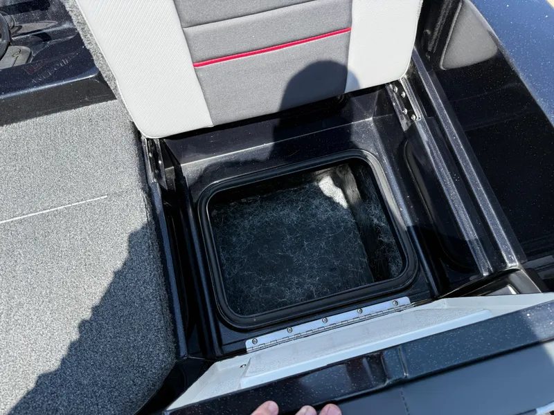 Slide: The Image of Open storage compartment in 2022 Ranger 1880MS boat, featuring gray and black interior. - 30